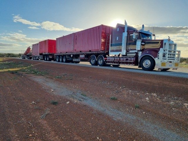 G&S Hannah Transport triple road train on red dirt road in remote Western Australia